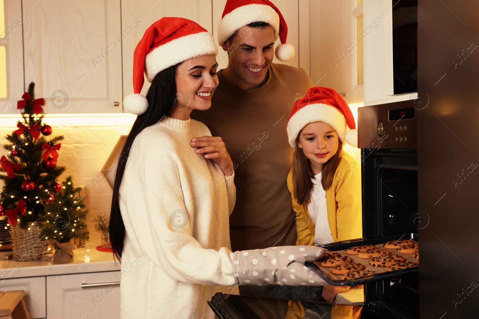 Photo of Happy family baking delicious Christmas cookies at home