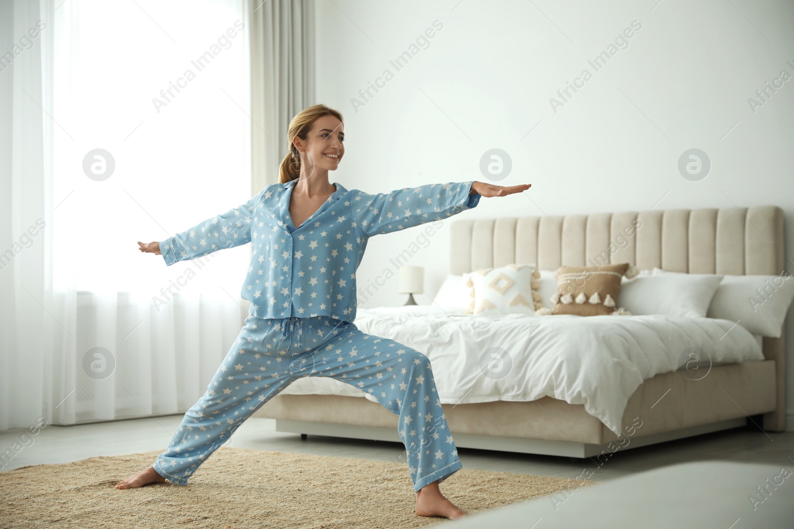 Photo of Young woman doing exercises at home. Morning fitness