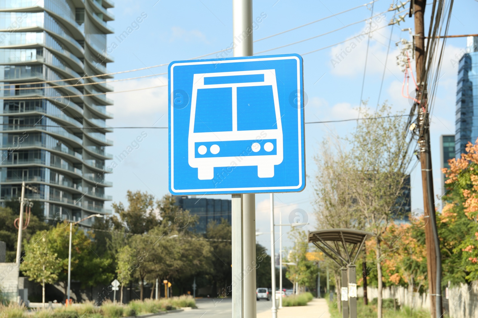 Photo of Post with bus stop road sign on city street