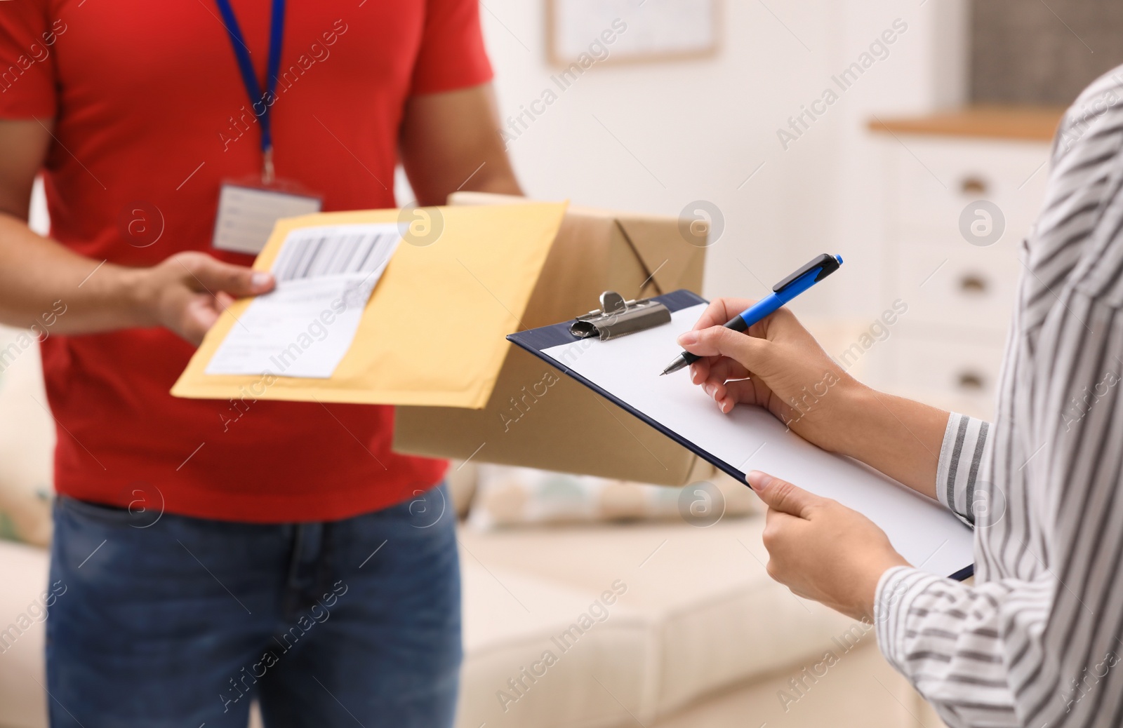 Photo of Woman signing for delivered parcels at home, closeup. Courier service