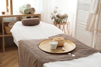 Photo of Stylish room interior with massage table in spa salon