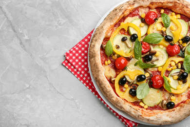 Tasty vegetable pizza on light grey table, top view. Space for text