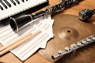 Photo of Set of different musical instruments on wooden background, closeup