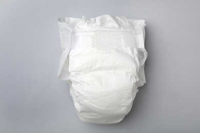 Photo of Baby diaper on light grey background, top view