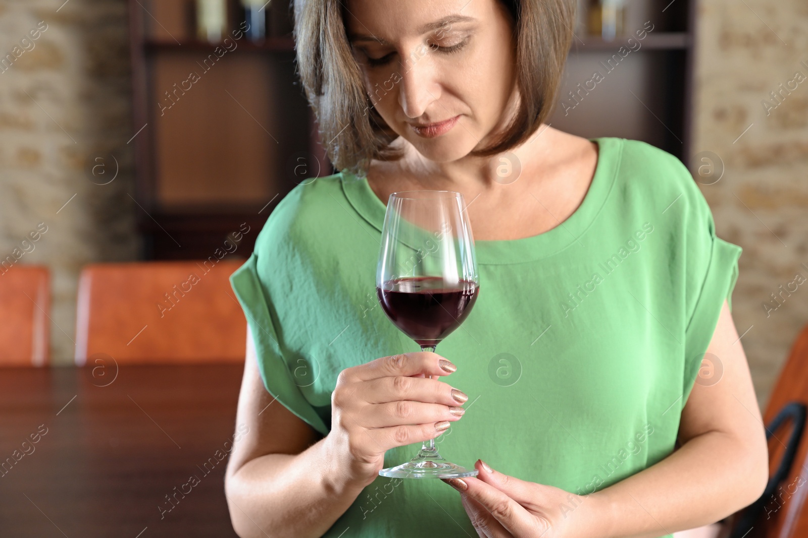 Photo of Woman with glass of red wine indoors