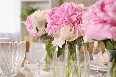 Photo of Stylish table setting with beautiful peonies indoors, closeup