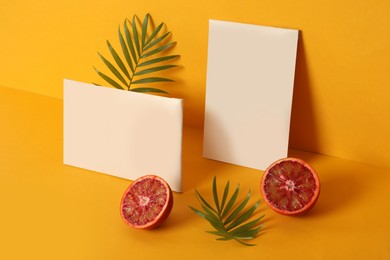 Photo of Scented sachets, leaves and red orange on color background