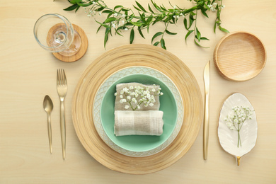 Photo of Elegant table setting with flowers and leaves, flat lay