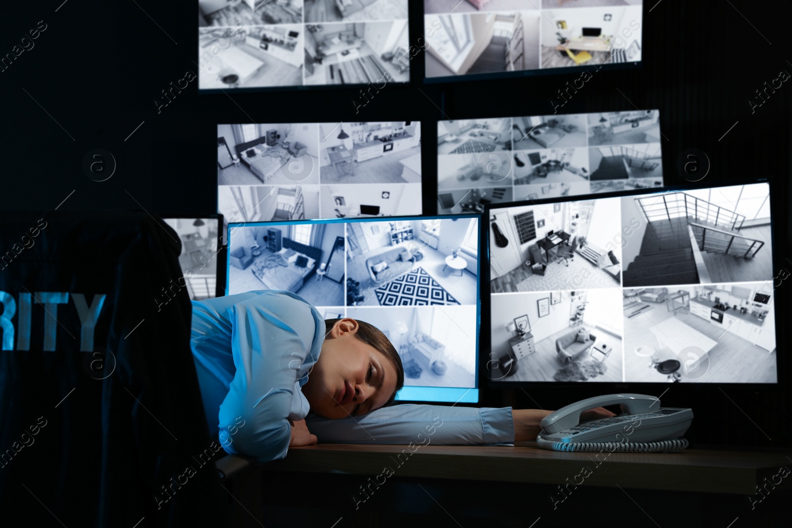 Photo of Tired security guard sleeping in office at night