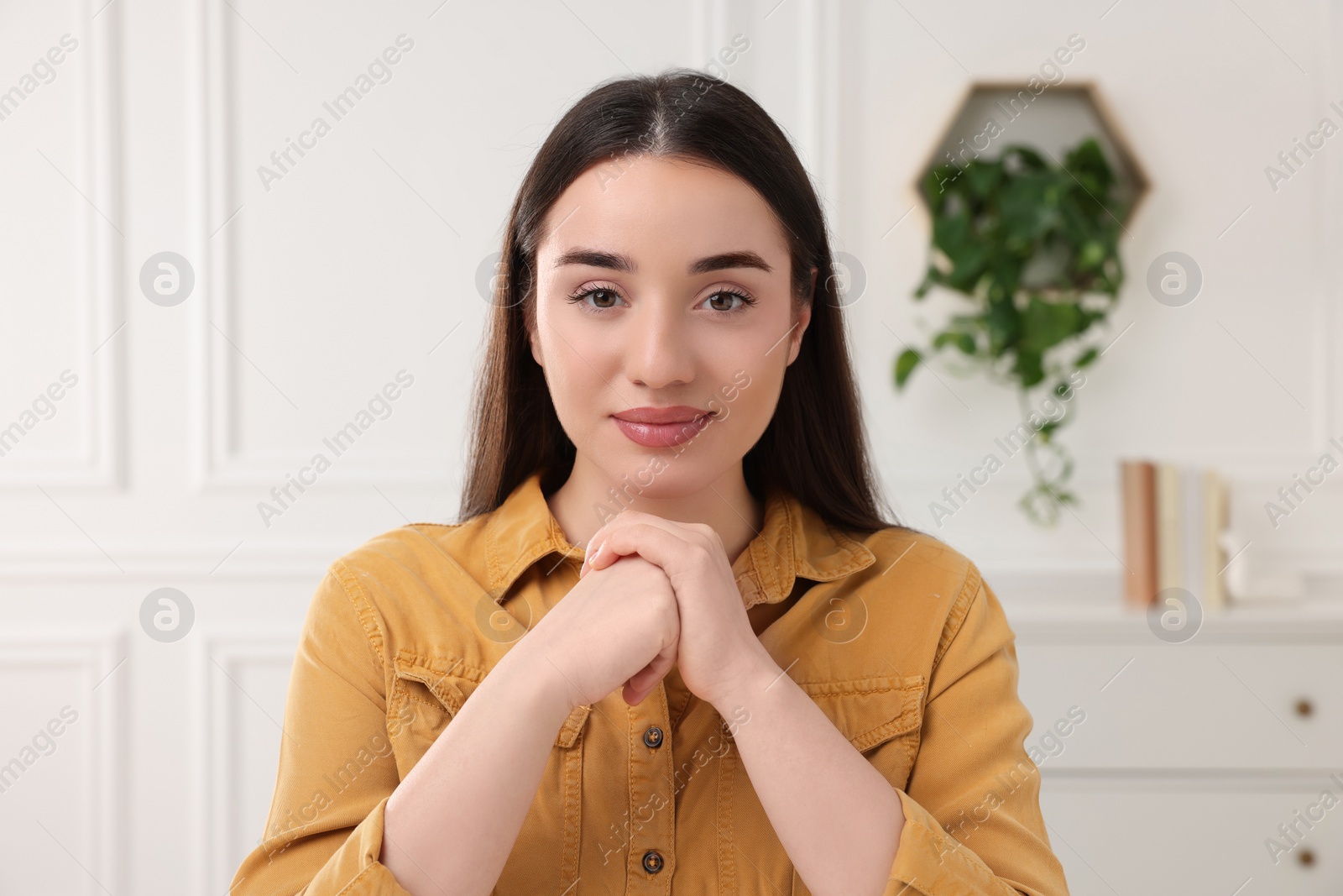 Photo of Beautiful young woman having online video call at home, view from camera