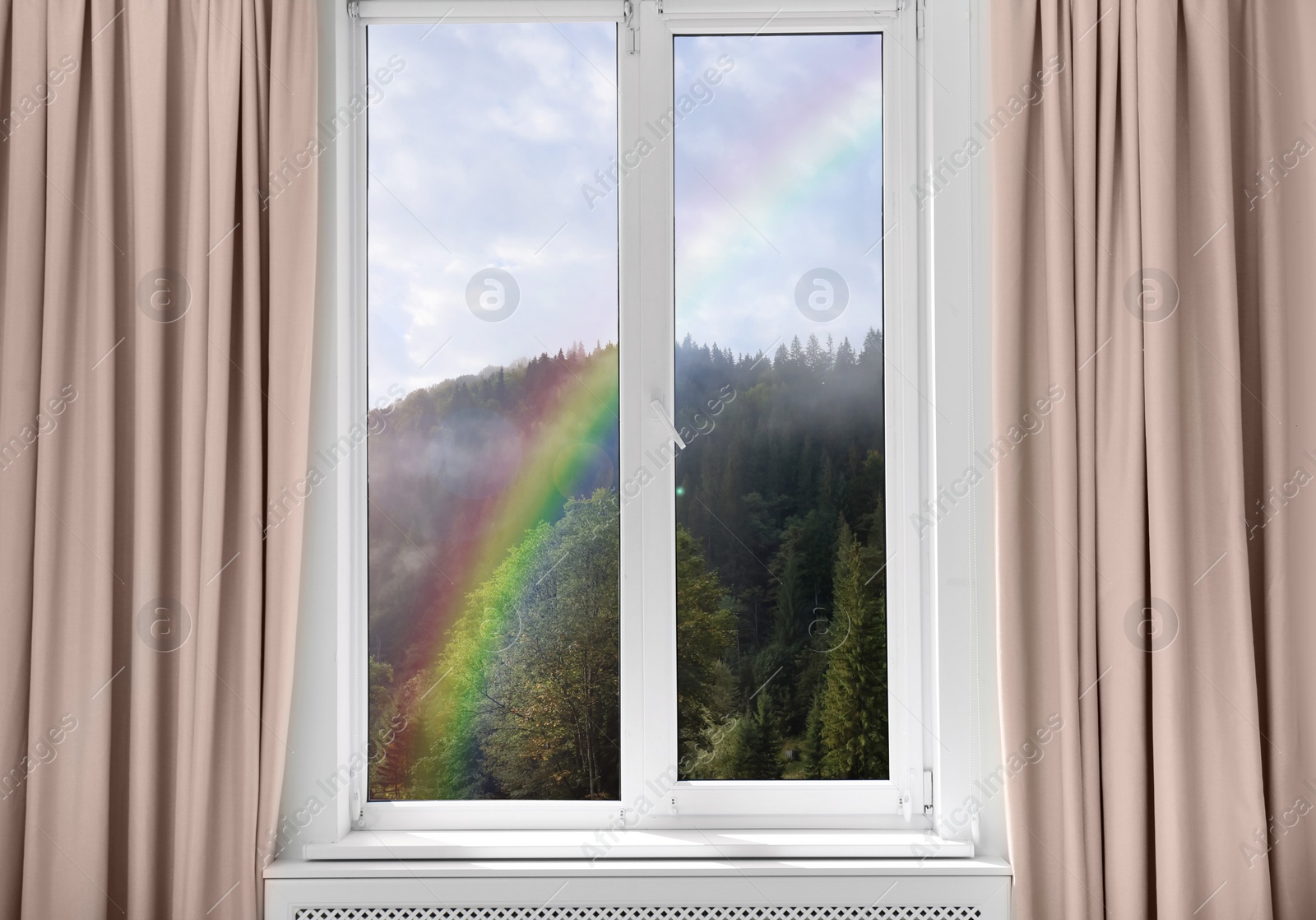 Image of View of beautiful rainbow in mountains through window