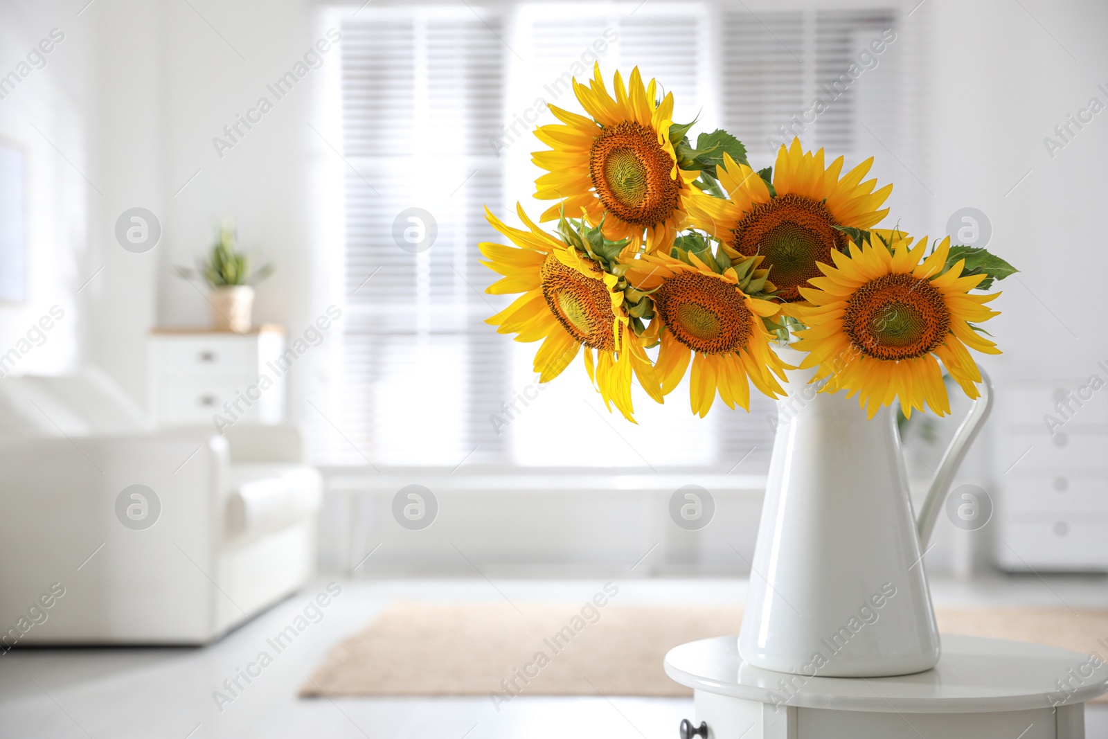 Photo of Beautiful bouquet of sunflowers in vase on table indoors. Space for text