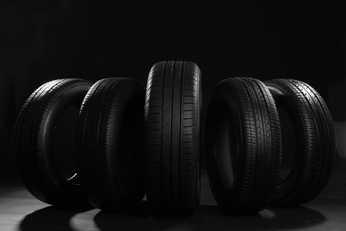 Photo of New car tires on black background