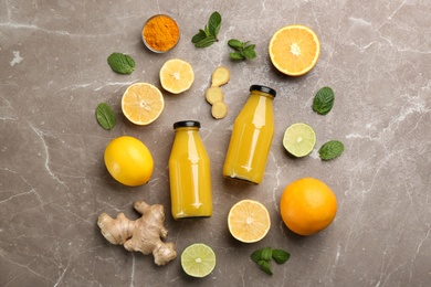 Photo of Flat lay composition with immunity boosting drink and ingredients on grey table