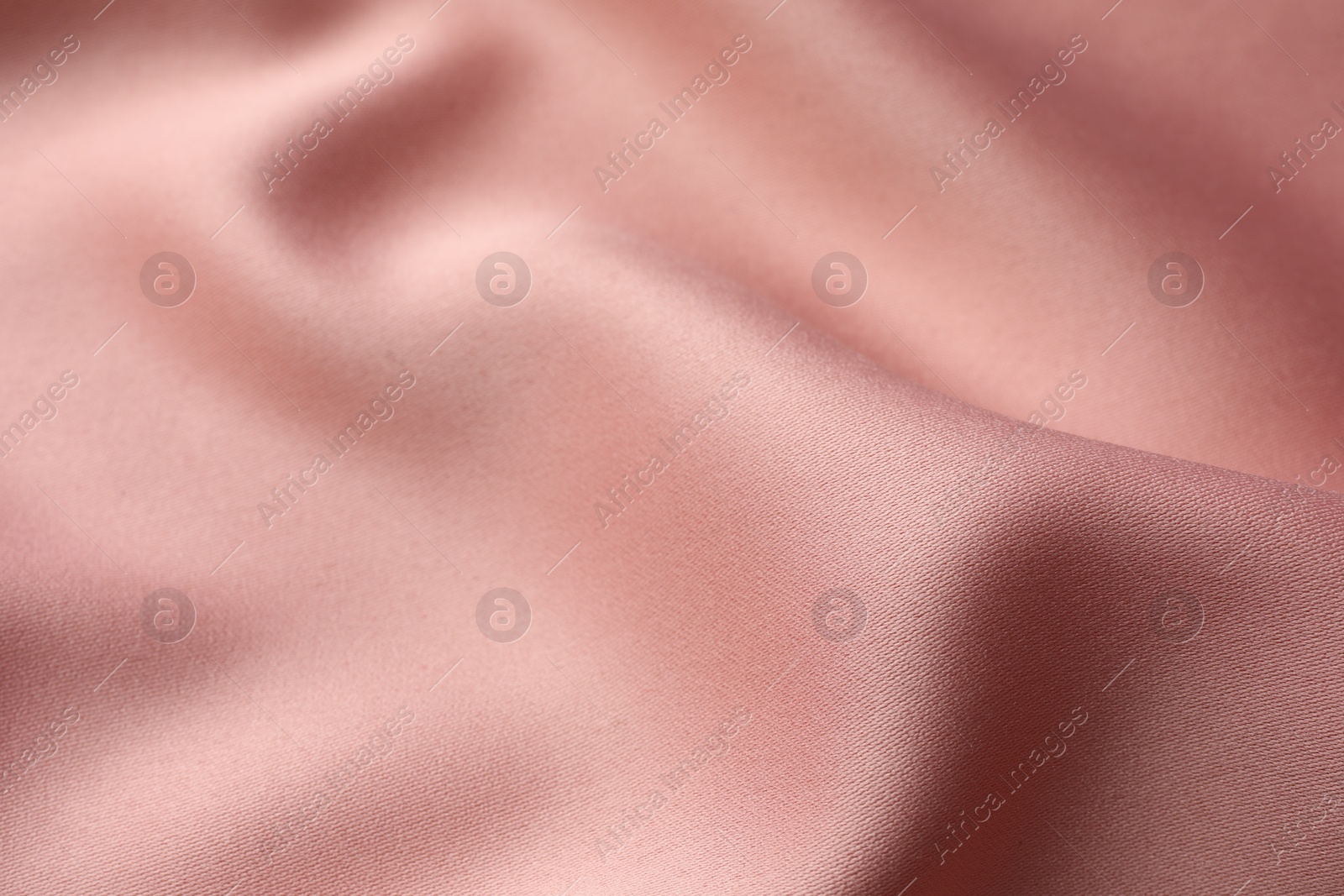 Photo of Texture of pink silk fabric as background, closeup