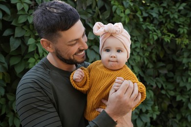 Photo of Happy father with his little baby outdoors on sunny day