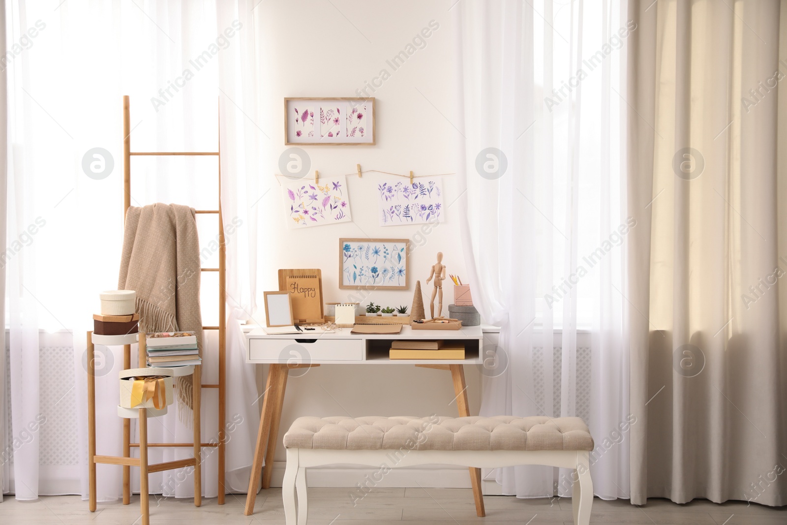 Photo of Stylish room interior with creative workplace near white wall