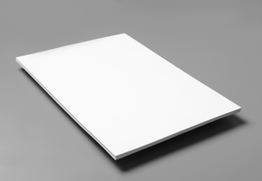 Photo of Blank paper sheets for brochure on grey background. Mock up