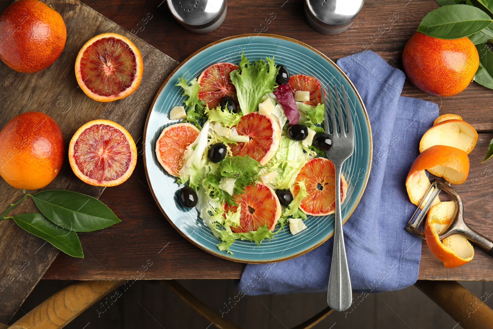 Photo of Delicious sicilian orange salad served on wooden table, flat lay