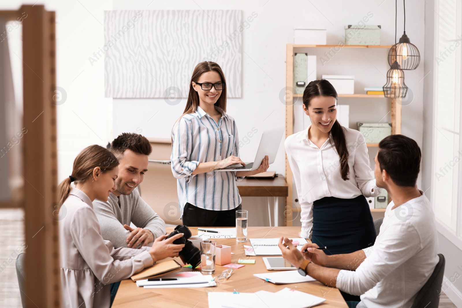 Photo of Team of professional journalists working in office