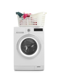 Modern washing machine and basket with laundry on white background