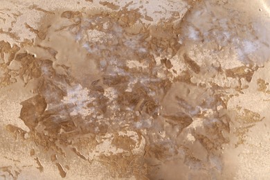 Photo of Texture of golden spray paint as background, closeup