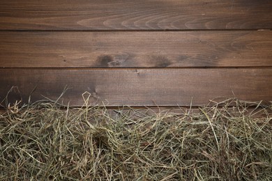 Photo of Dried hay on wooden table, top view. Space for text