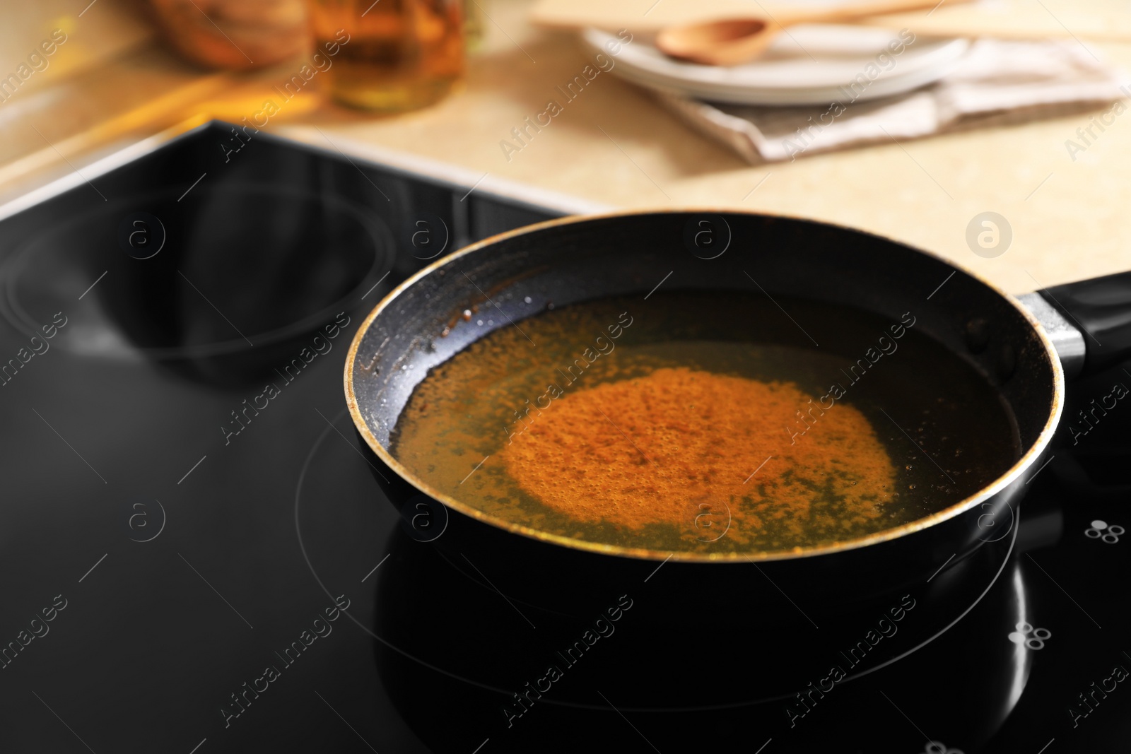 Photo of Frying pan with used cooking oil on stove