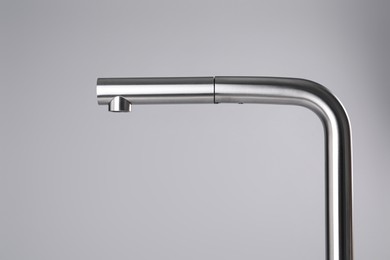 Photo of Modern pull out kitchen faucet on grey background