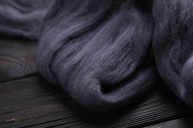 Photo of Felting wool on wooden table, closeup view