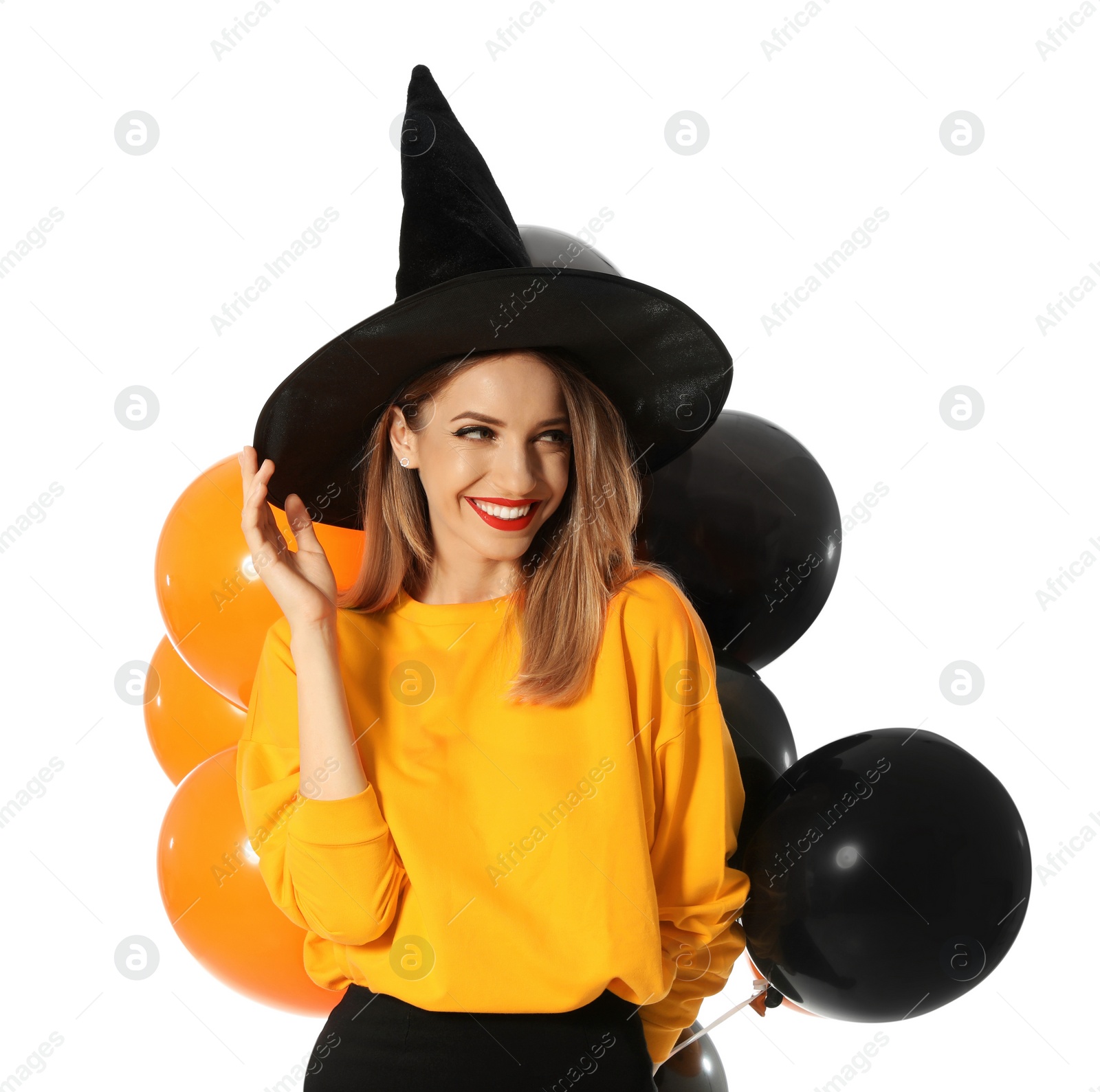 Photo of Beautiful woman wearing witch costume with balloons for Halloween party on white background