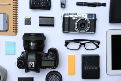 Flat lay composition with equipment for professional photographer on white background