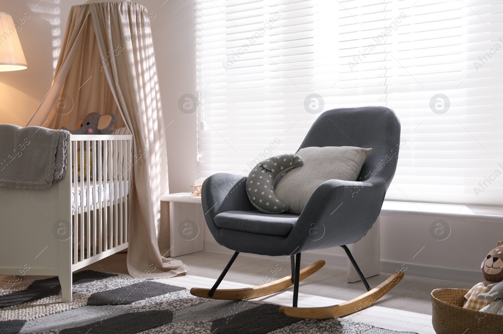 Photo of Baby room interior with comfortable crib and rocking chair