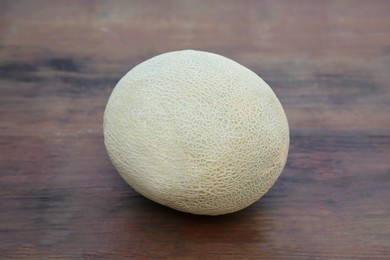 Whole ripe cantaloupe melon on wooden table