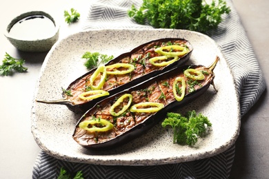 Fried eggplant slices with chili peppers on plate