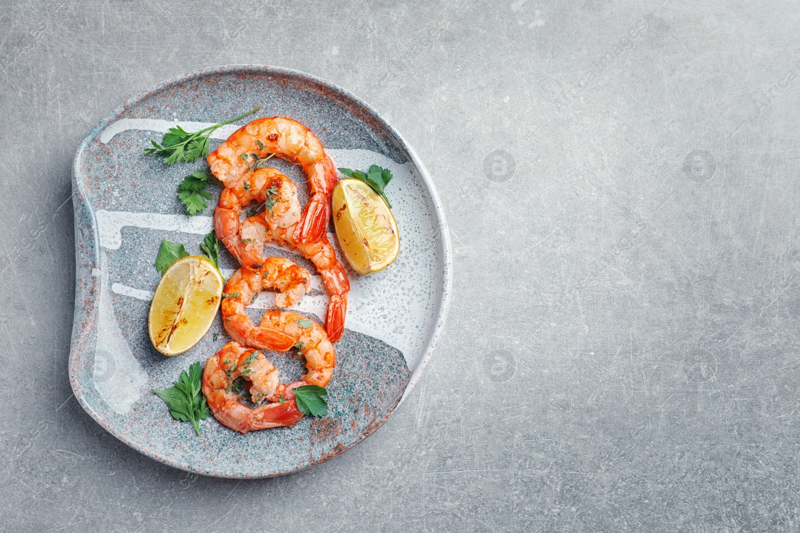 Photo of Plate with delicious fried shrimps and lime on light background, top view