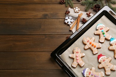 Delicious Christmas cookies and fir branches on wooden table, flat lay. Space for text