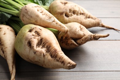 Photo of Fresh sugar beets on wooden table, closeup view