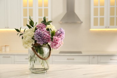 Photo of Bouquet with beautiful hydrangea flowers on white marble table. Space for text