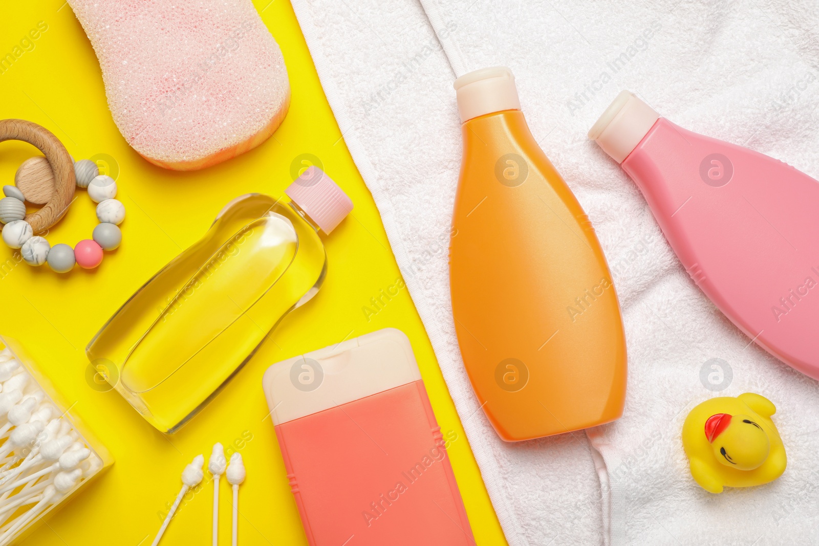 Photo of Flat lay composition with baby cosmetic products on yellow background