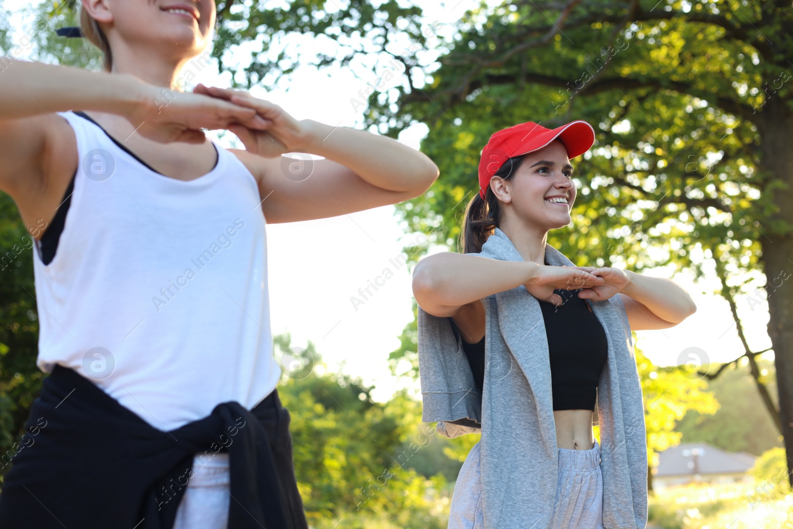 Photo of Women doing morning exercise in park on sunny day