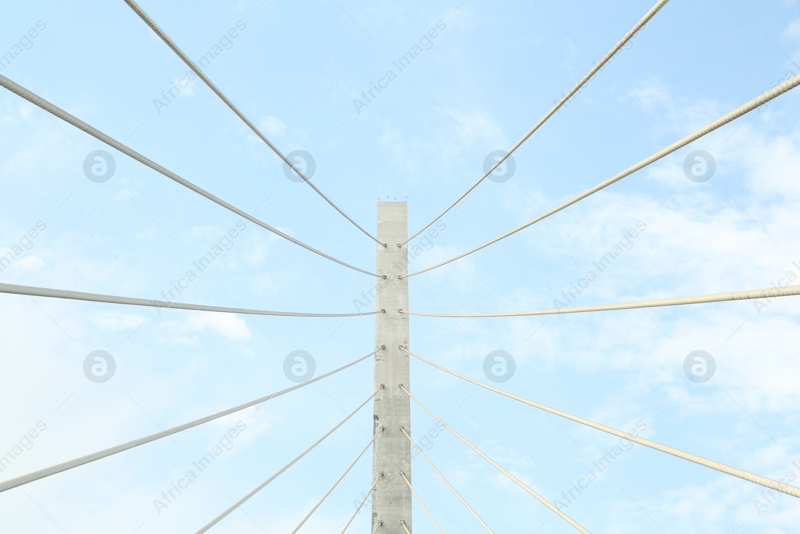 Photo of Beautiful modern bridge against blue cloudy sky, low angle view