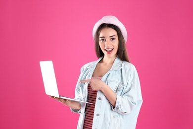 Photo of Portrait of young woman in casual outfit with laptop on color background