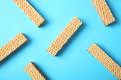 Flat lay composition with delicious crispy wafers on blue background