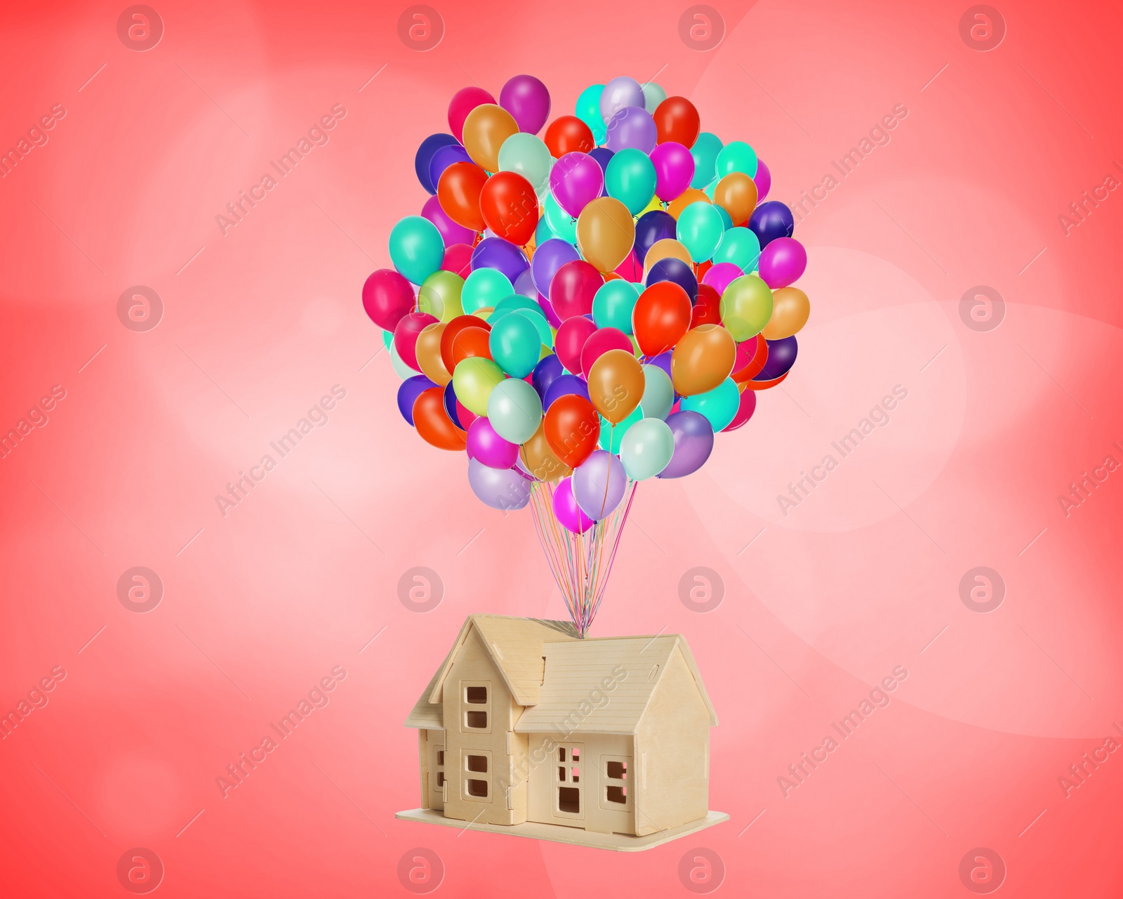 Image of Many balloons tied to model of house flying on red background