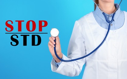 Image of STOP STD. Doctor with stethoscope on light blue background, closeup