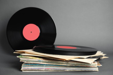 Stack of vintage vinyl records on grey background