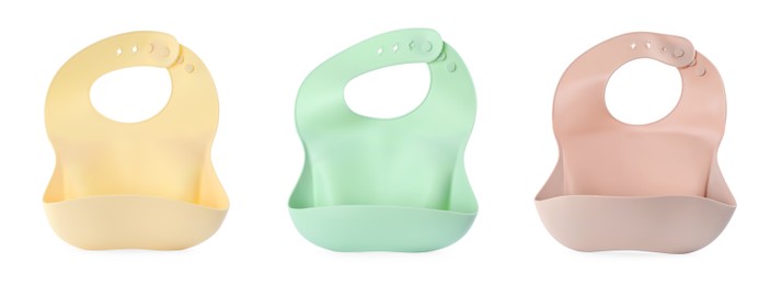 Set with different silicone baby bibs on white background, top view. Banner design