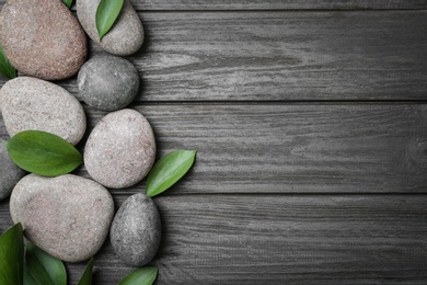 Spa stones and leaves on wooden background