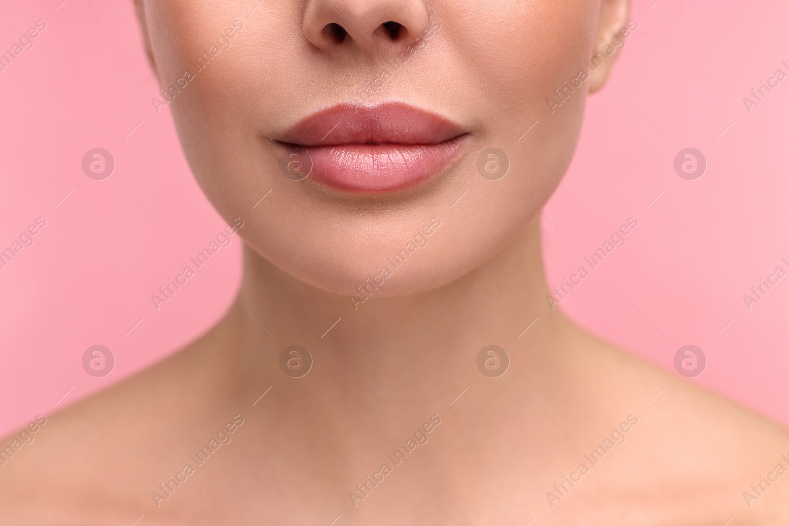 Photo of Woman with beautiful lips on pink background, closeup